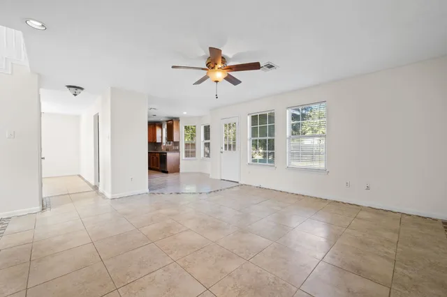a view of a livingroom with a ceiling fan and window