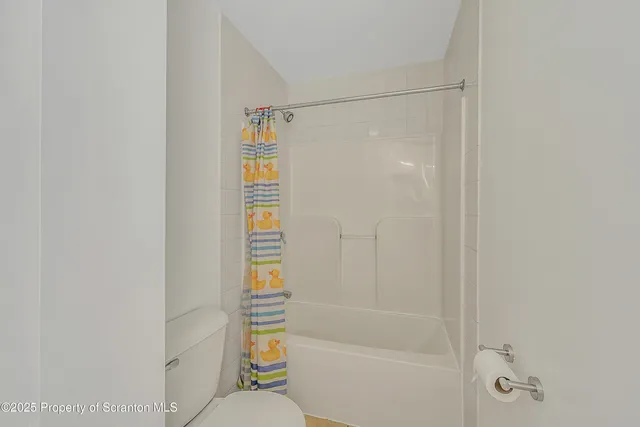 a bathroom with a shower and a toilet