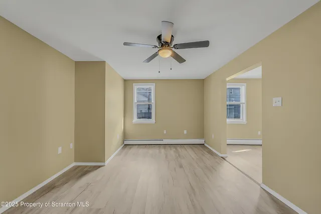 wooden floor in an empty room with a window