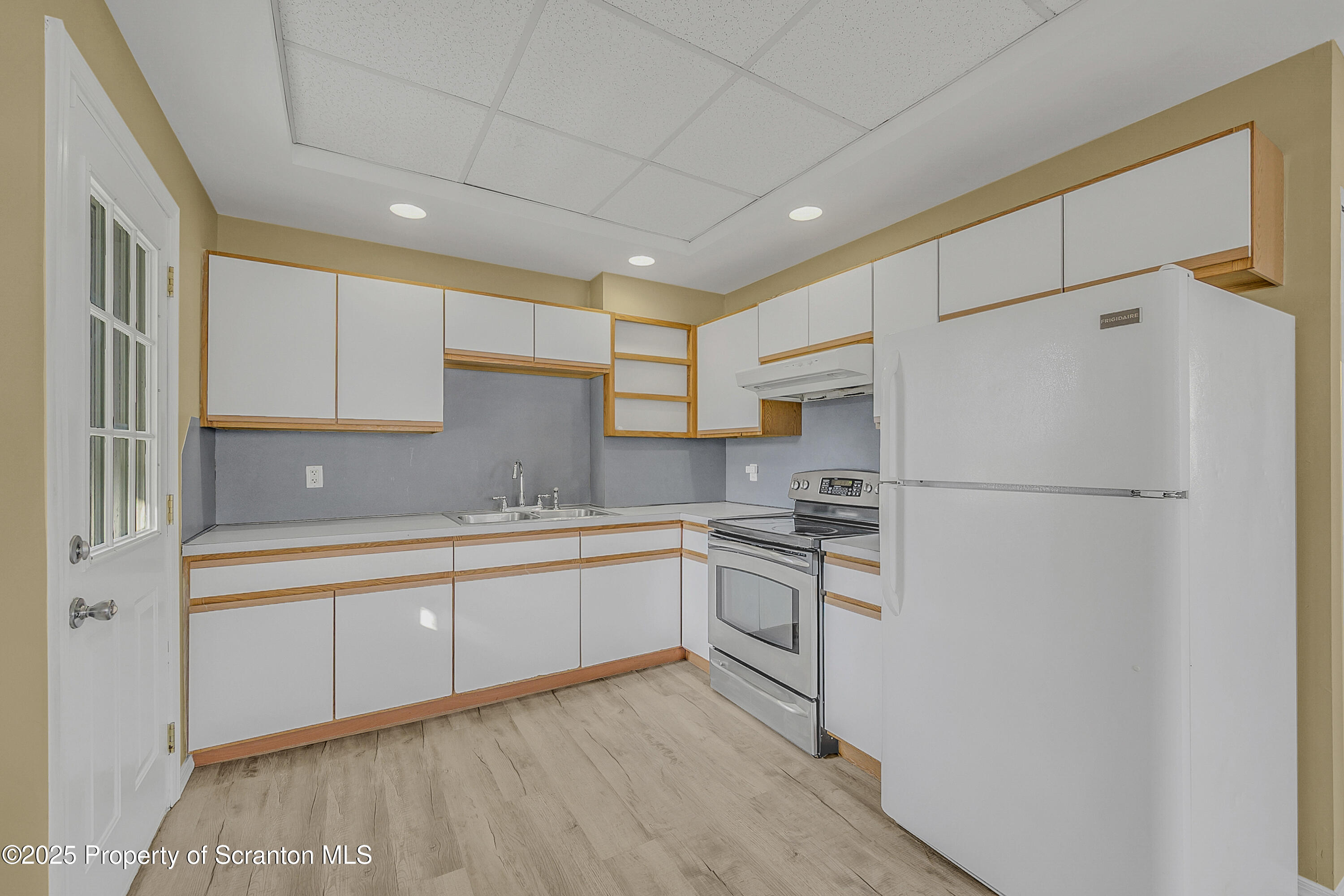 538 Birch Street, Unit 3 Scranton, PA 18505 - Photo 9 of 18 a kitchen with white cabinets and white appliances