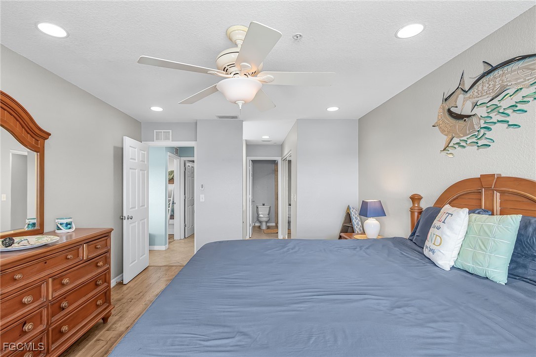 16641 Stringfellow Road, Unit 506 Bokeelia, FL 33922 - Photo 15 of 43 a bedroom with a bed and wooden floor