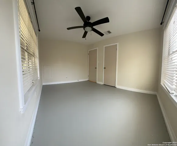 a view of room with a ceiling fan and window