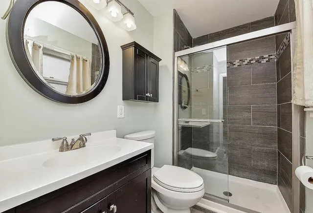 a bathroom with a sink a toilet and a mirror