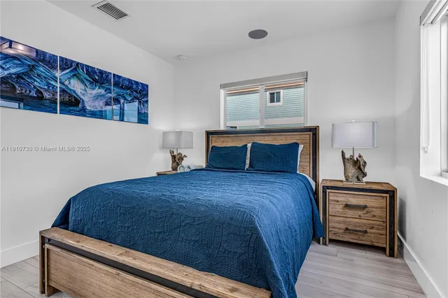 a bedroom with a bed and a night stand