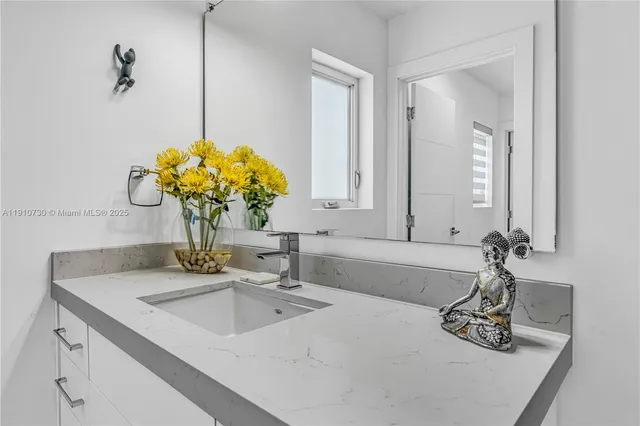 a bathroom with a sink and a mirror