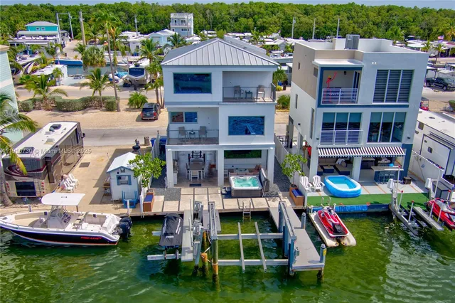a aerial view of a house with swimming pool and a yard