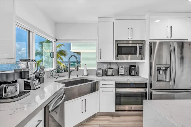 a kitchen with stainless steel appliances a sink a stove and a refrigerator