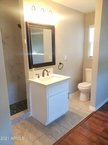 a bathroom with a sink vanity and a mirror