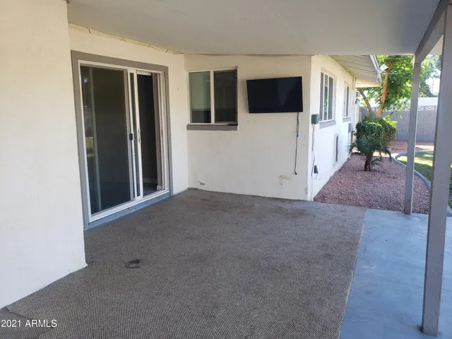a view of a livingroom with an empty space and a window