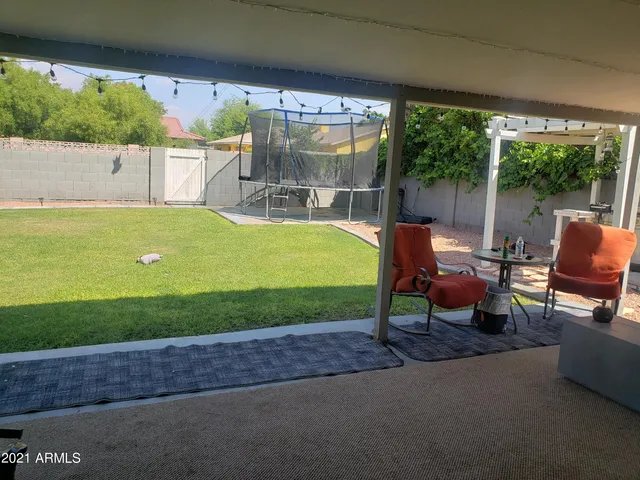 a view of a chairs and table in the patio