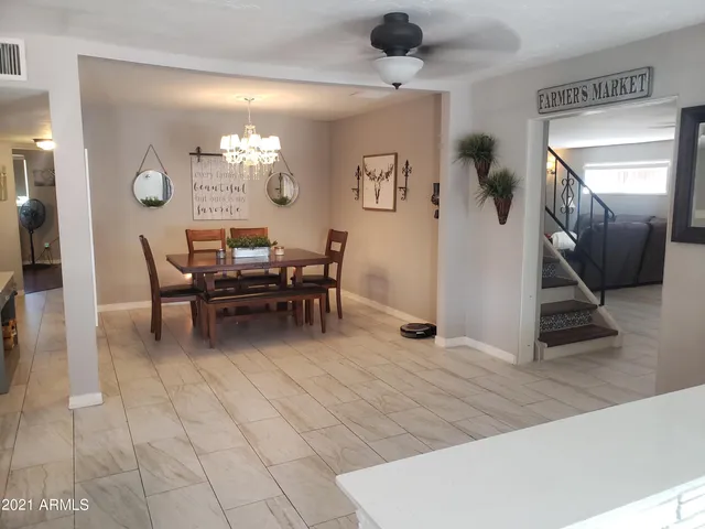 a dining room with furniture and a chandelier