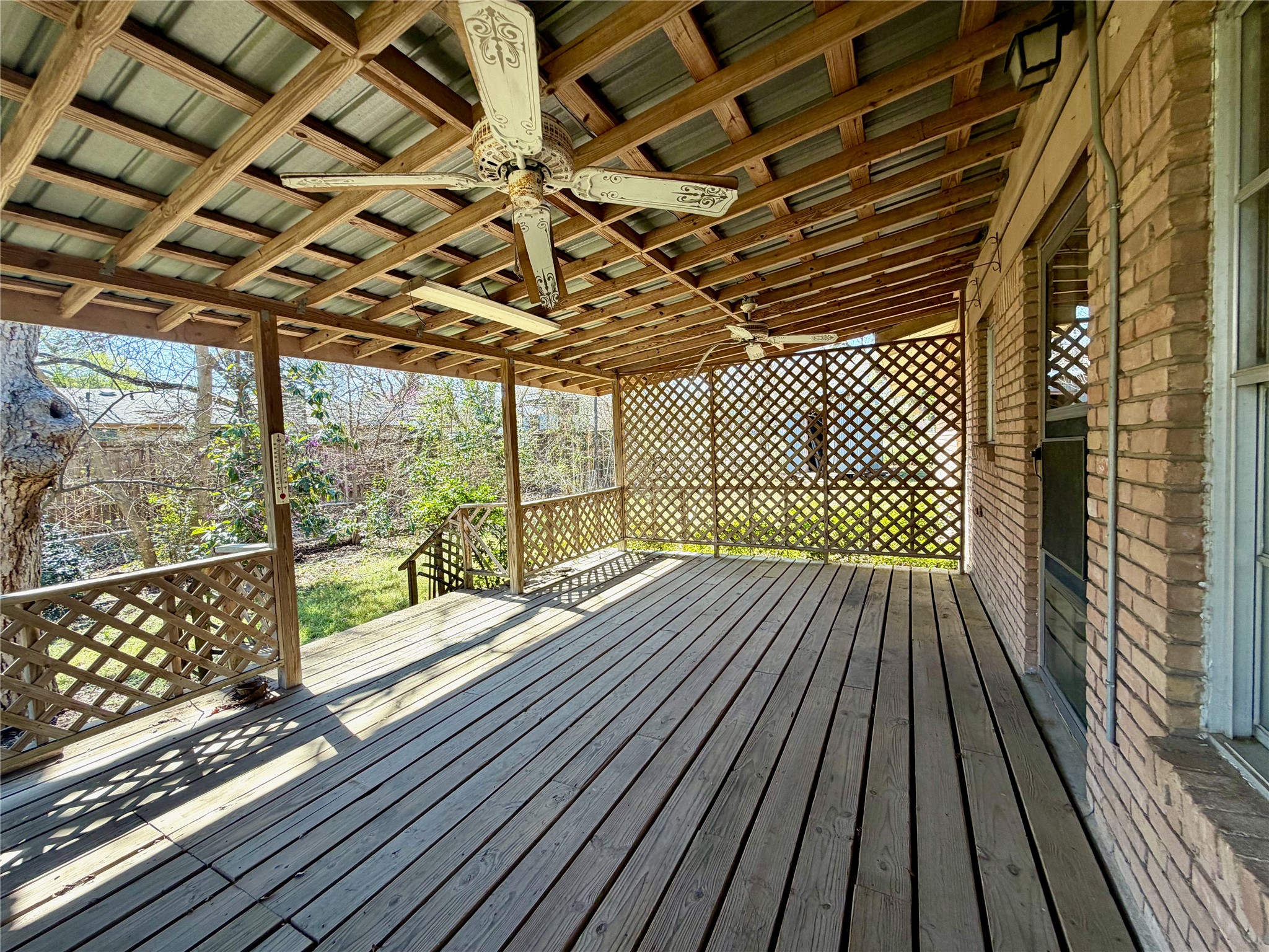 305 West Caddo Street Austin, TX 78753 - Photo 13 of 13 Large covered back deck with ceiling fans.