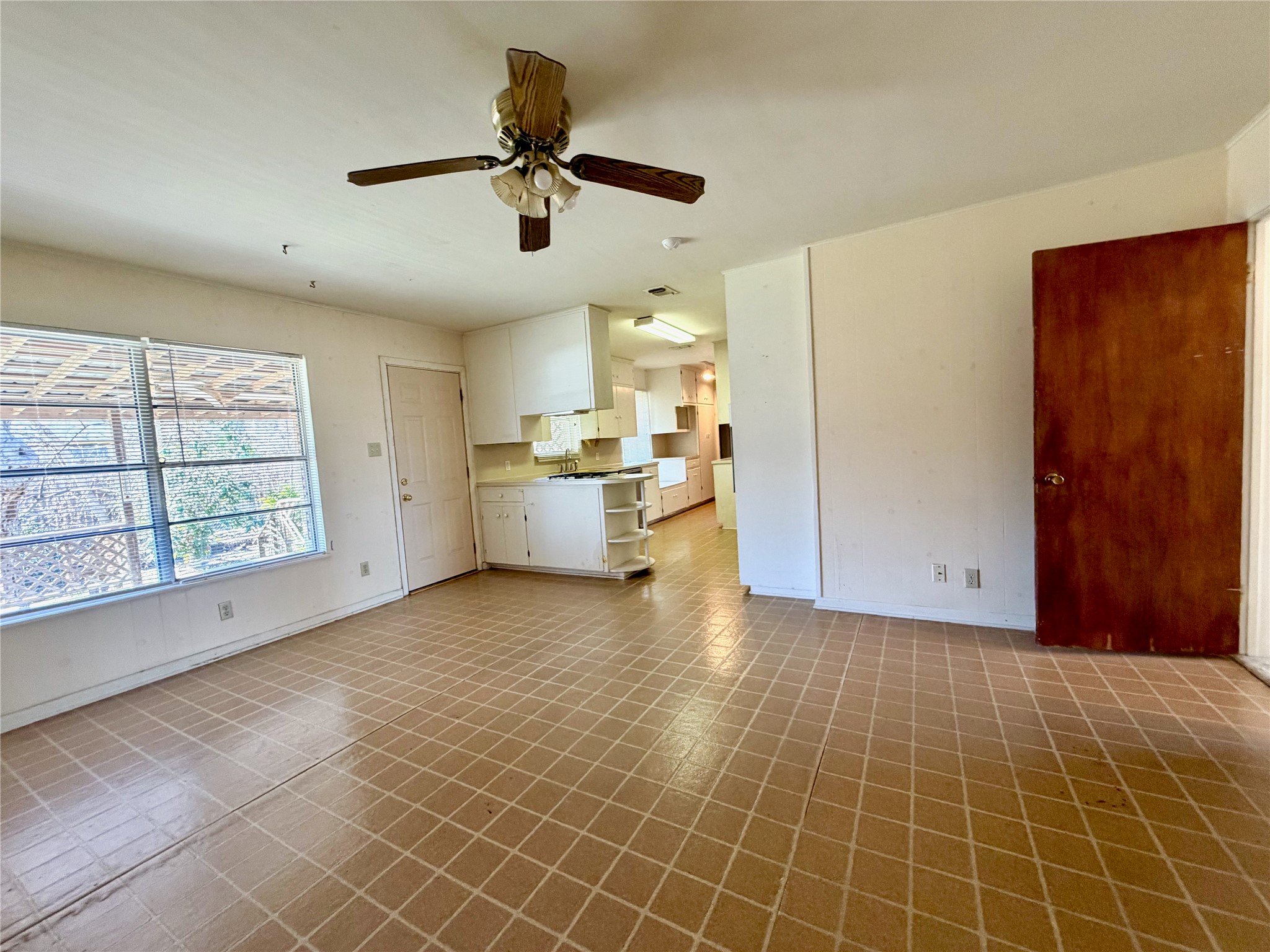 305 West Caddo Street Austin, TX 78753 - Photo 5 of 13 Additional dining/living space open to kitchen with window to the backyard.