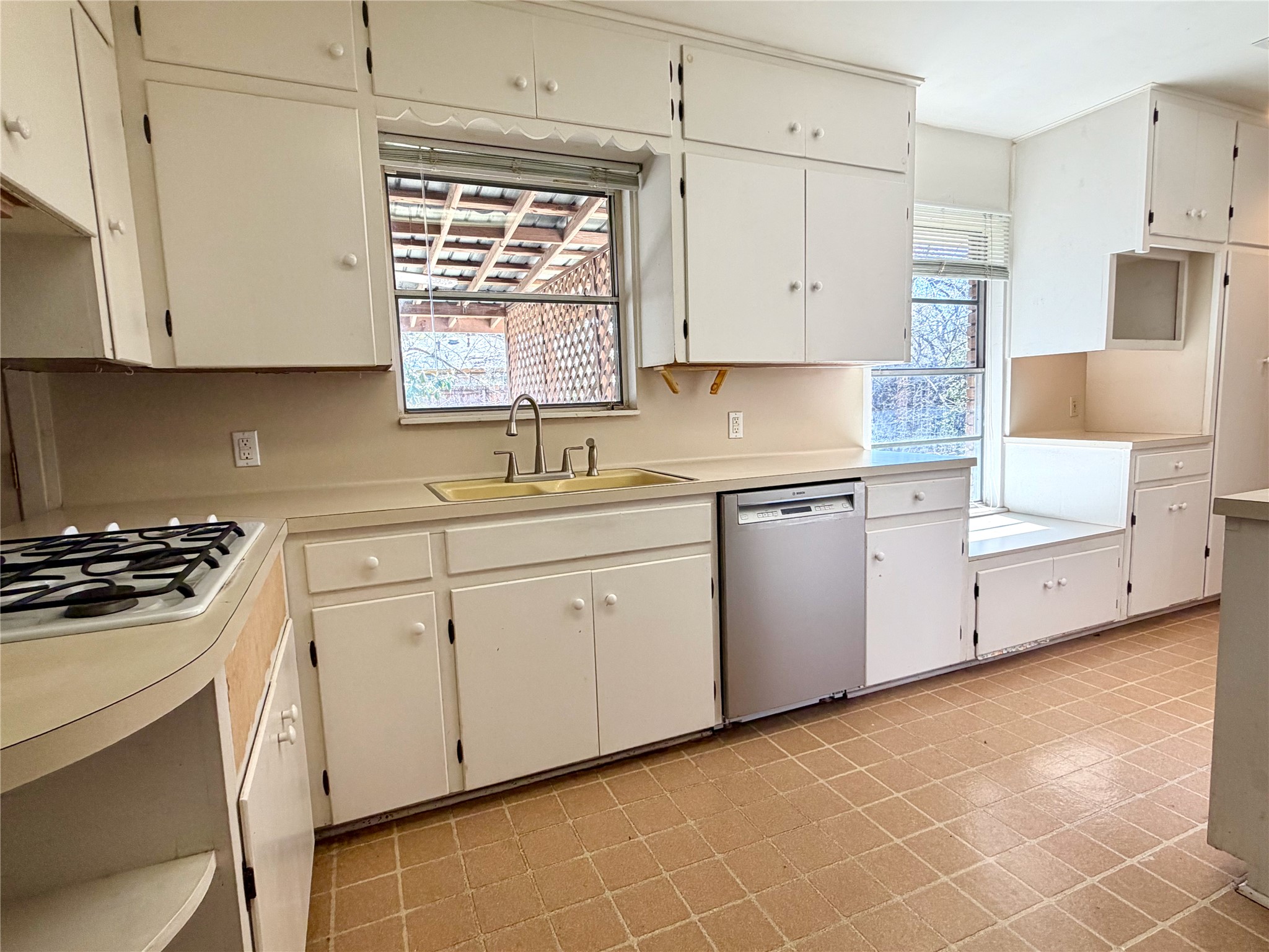305 West Caddo Street Austin, TX 78753 - Photo 6 of 13 Tons of storage and light in this galley style kitchen.