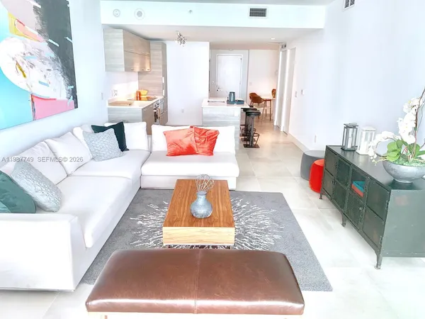 a view of a dining room with furniture and a chandelier