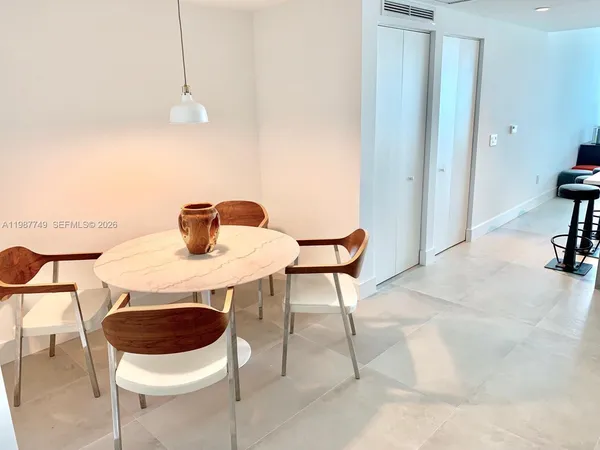 a utility room with dryer washer and a view of kitchen