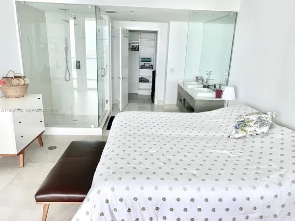 a bathroom with a double vanity sink a toilet and shower