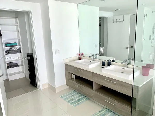 a bedroom with a bed and a mirror