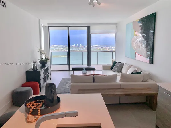 a living room with furniture and a large window