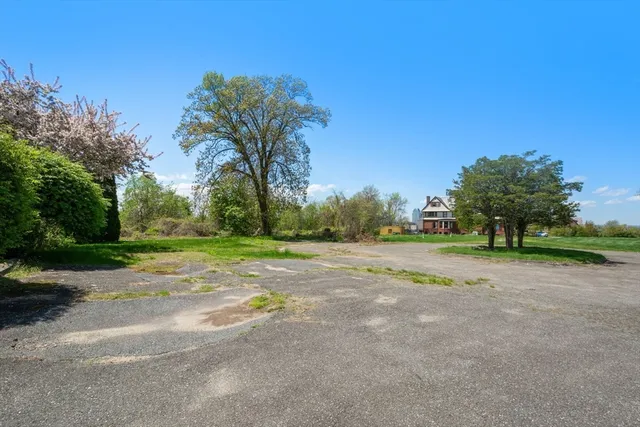 a view of a street with a yard