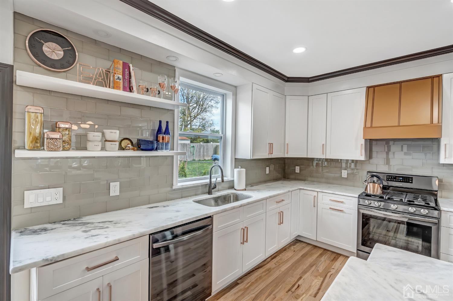 22 Stiles Road Edison, NJ 08817 - Photo 18 of 48 a kitchen with stainless steel appliances granite countertop a sink stove and cabinets