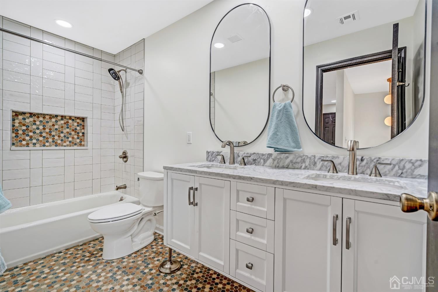 22 Stiles Road Edison, NJ 08817 - Photo 26 of 48 a bathroom with a double vanity sink mirror and toilet