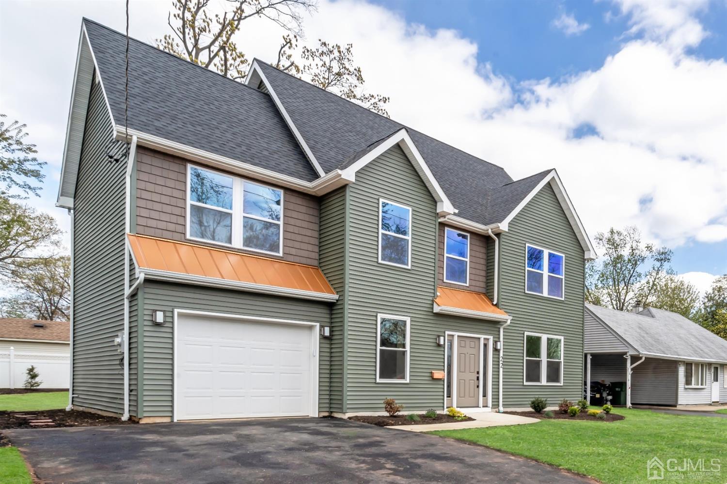 22 Stiles Road Edison, NJ 08817 - Photo 4 of 48 a front view of a house with a yard and garage