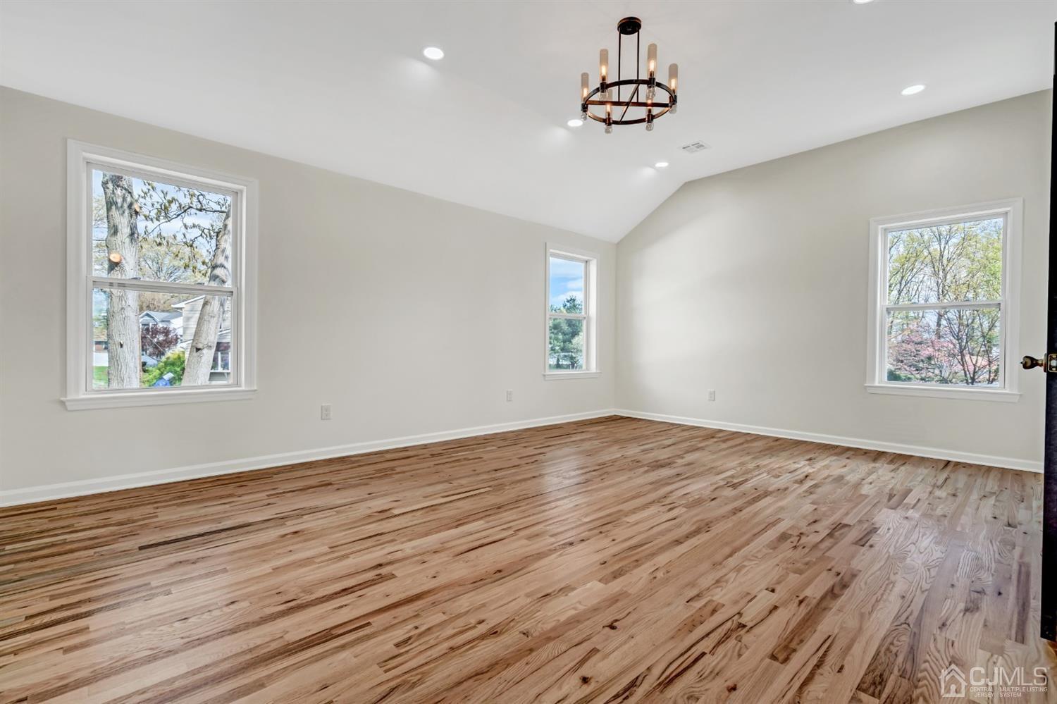 22 Stiles Road Edison, NJ 08817 - Photo 34 of 48 a view of an empty room with wooden floor and a window