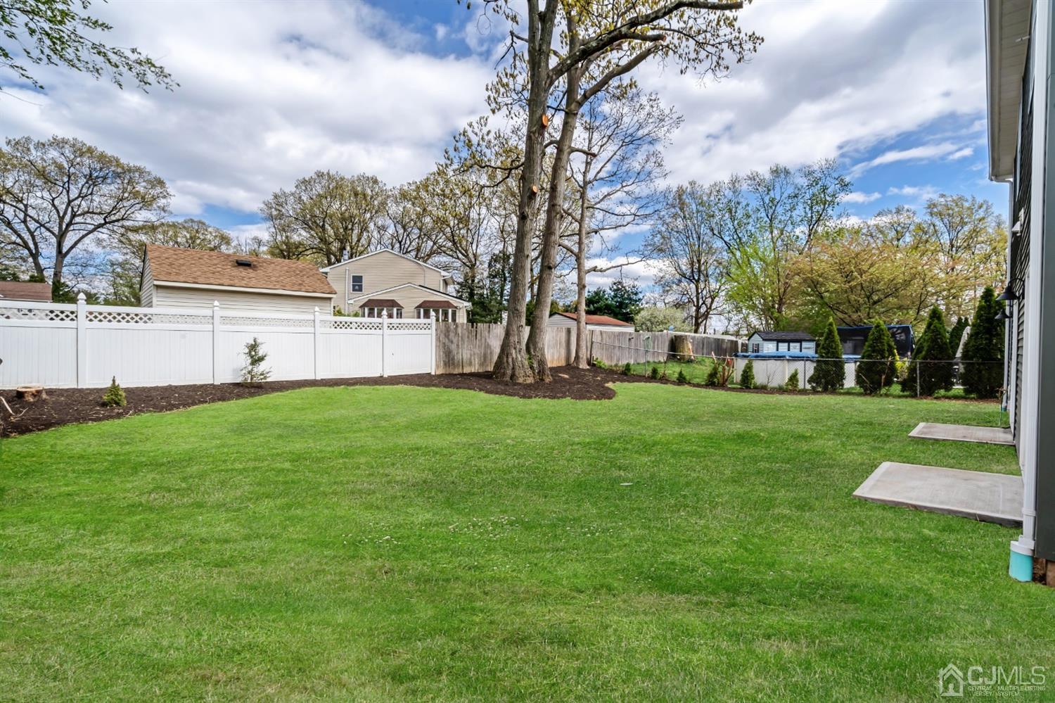 22 Stiles Road Edison, NJ 08817 - Photo 42 of 48 a view of white house with a big yard and large trees