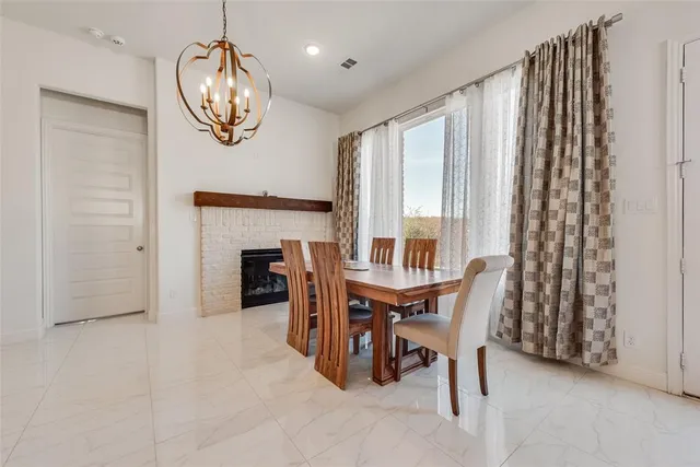 a kitchen with stainless steel appliances kitchen island granite countertop a table and chairs in it