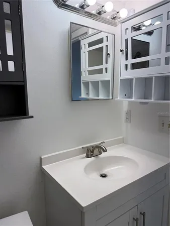 a bathroom with a sink a toilet and bathtub