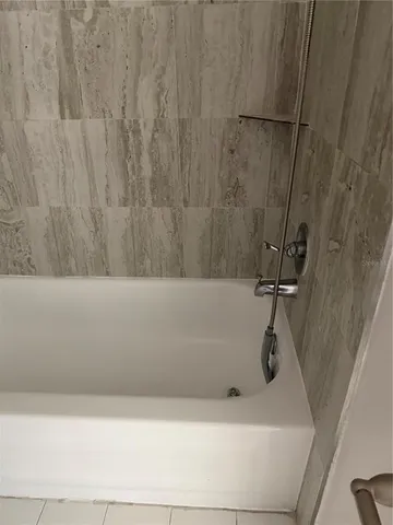 a view of a livingroom with an empty space and a window