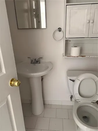 a bathroom with a toilet a sink and bathtub