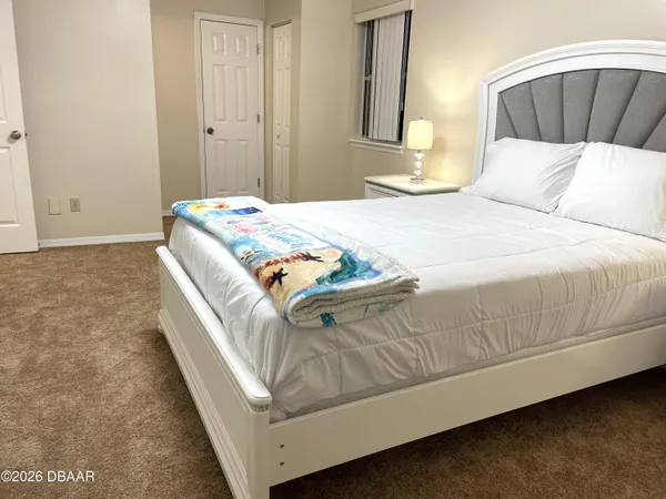 a bedroom with a bed and a table