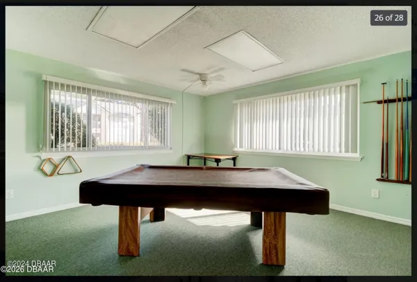 a room with table chairs and windows