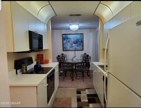 a kitchen with a sink cabinets and window