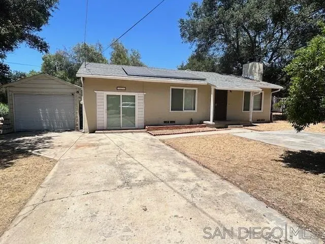 a backyard of a house with yard and outdoor seating