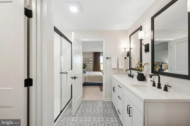 a spacious bathroom with a double vanity sink mirror and shower
