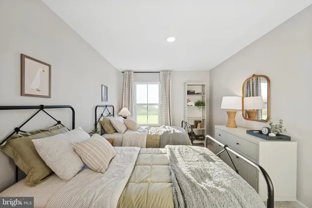 a bedroom with two beds and painting on the wall