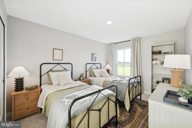 a bedroom with two beds and a couch