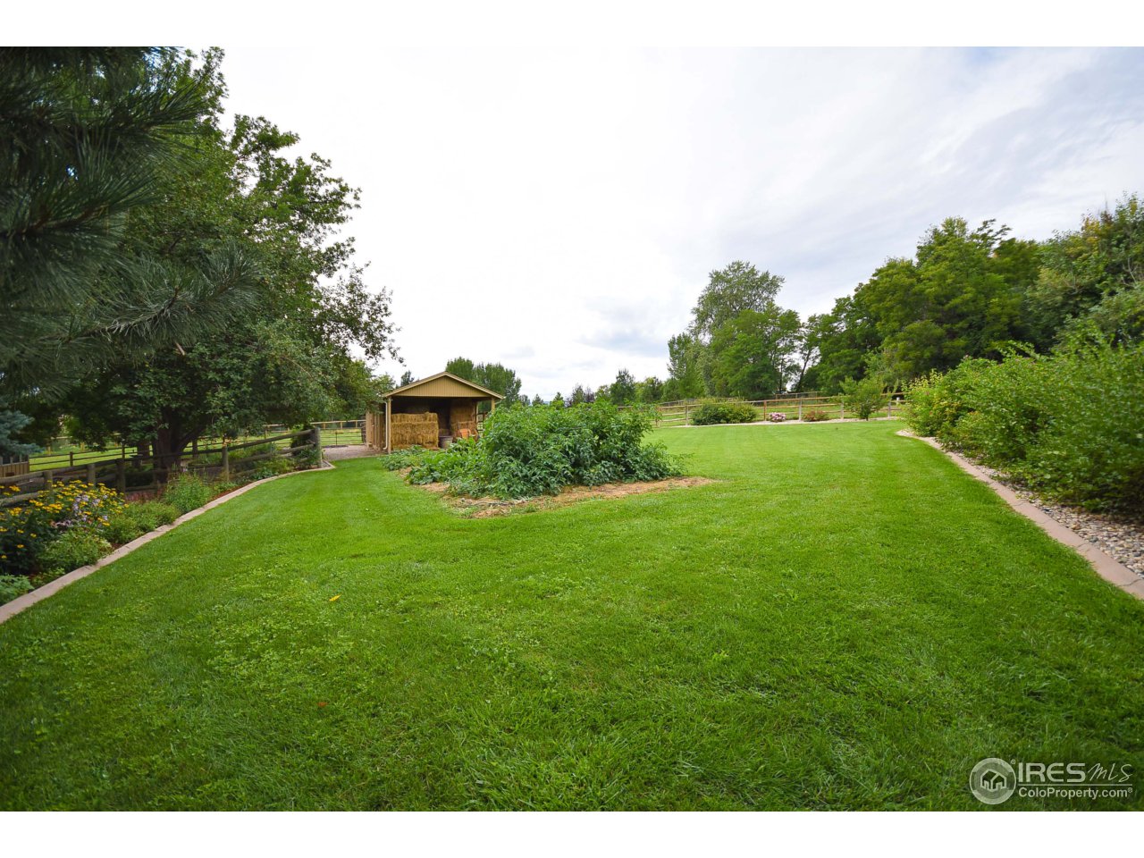 3501 Bayshore Road Fort Collins, CO 80524 - Photo 21 of 25 a view of a green field with wooden fence