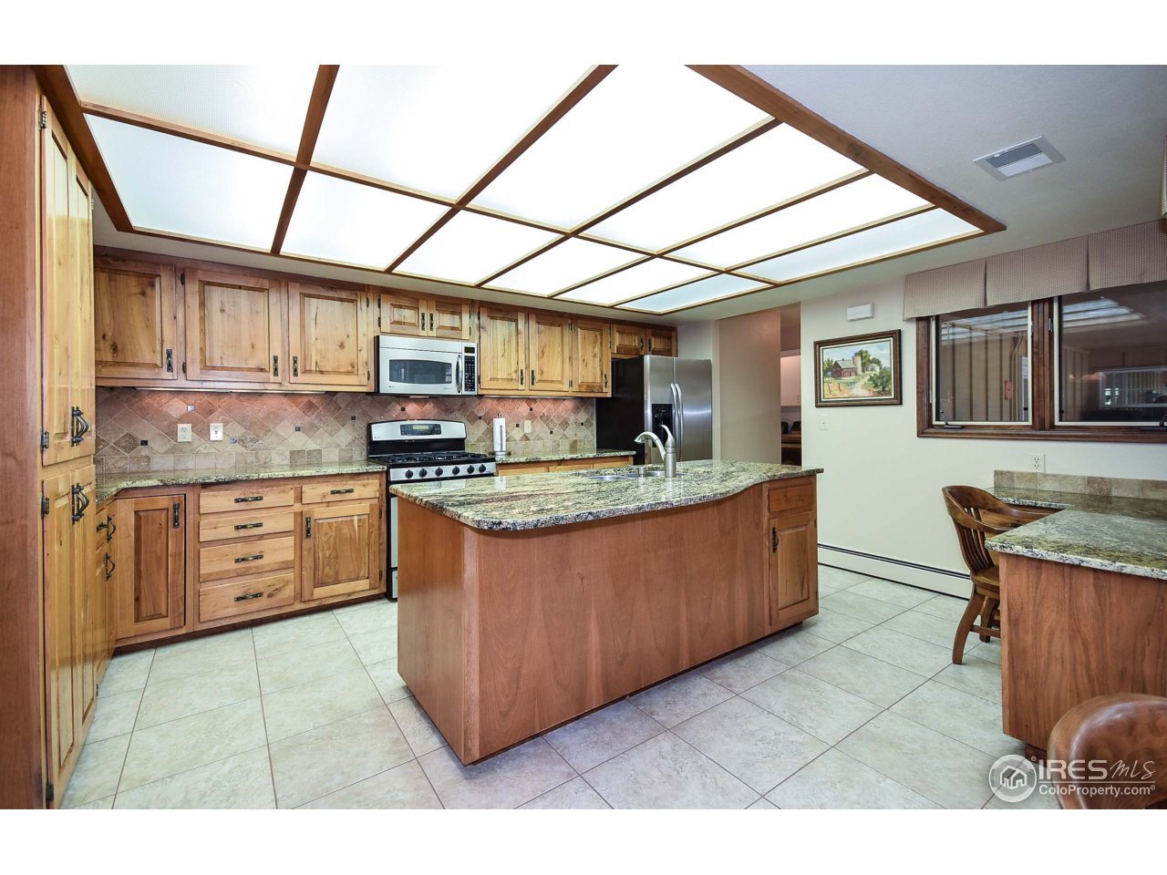 3501 Bayshore Road Fort Collins, CO 80524 - Photo 5 of 25 a kitchen with stainless steel appliances granite countertop a stove a sink and a microwave