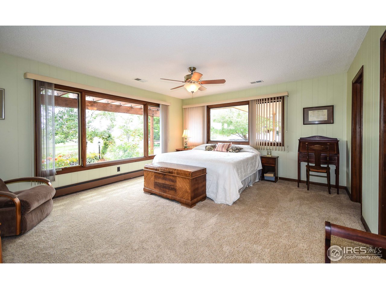 3501 Bayshore Road Fort Collins, CO 80524 - Photo 6 of 25 a spacious bedroom with a bed and a chandelier