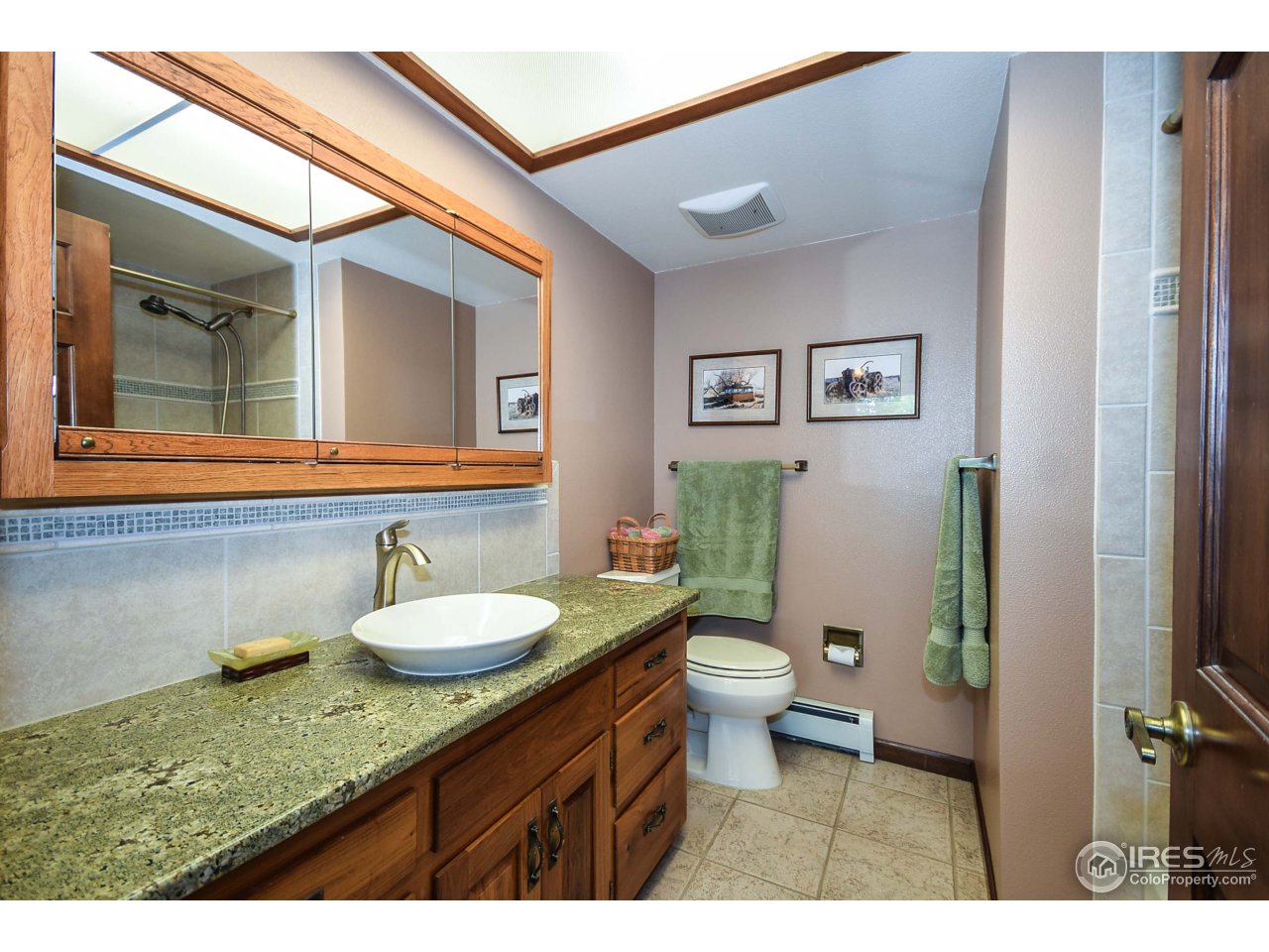 3501 Bayshore Road Fort Collins, CO 80524 - Photo 10 of 25 a bathroom with a granite countertop sink mirror vanity and toilet
