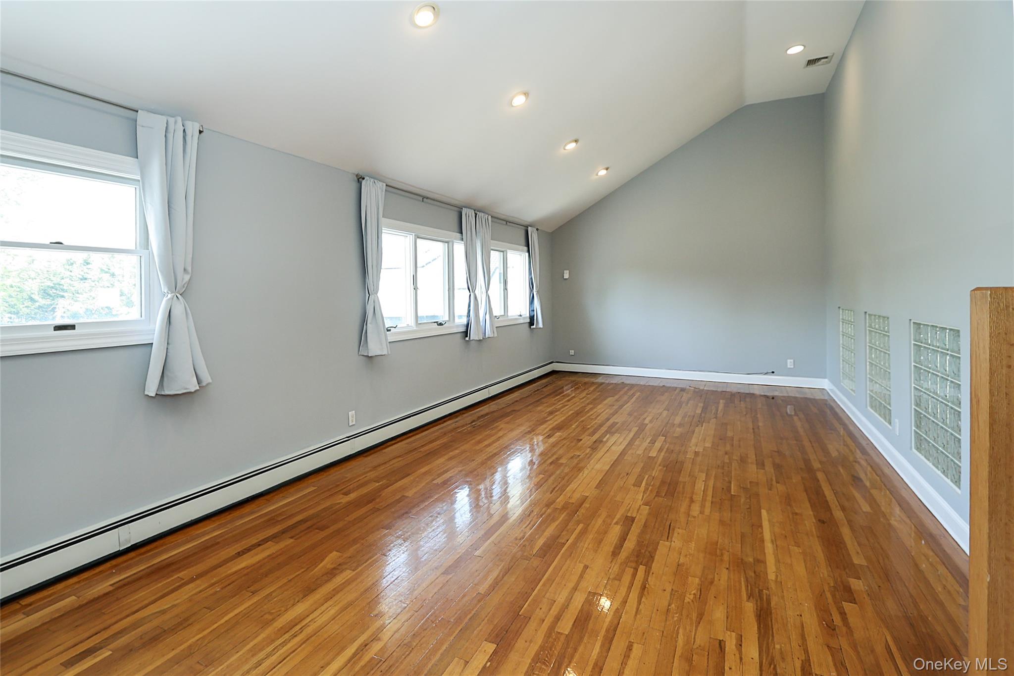 874 Seamans Nck Road Wantagh, NY 11793 - Photo 13 of 39 a view of empty room with wooden floor and fan