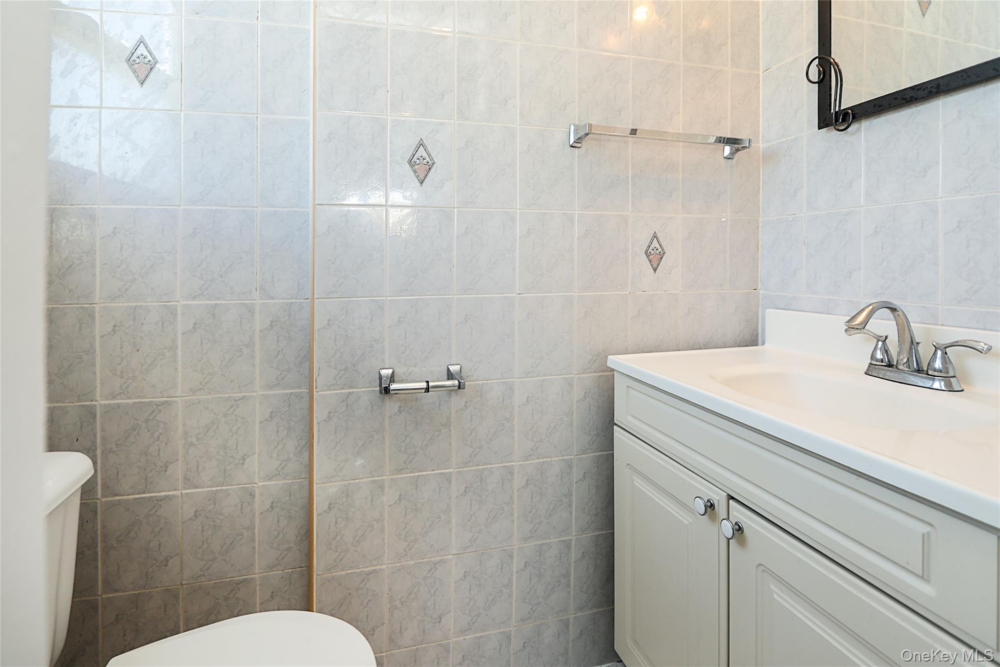 874 Seamans Nck Road Wantagh, NY 11793 - Photo 22 of 39 a bathroom with a sink toilet and shower