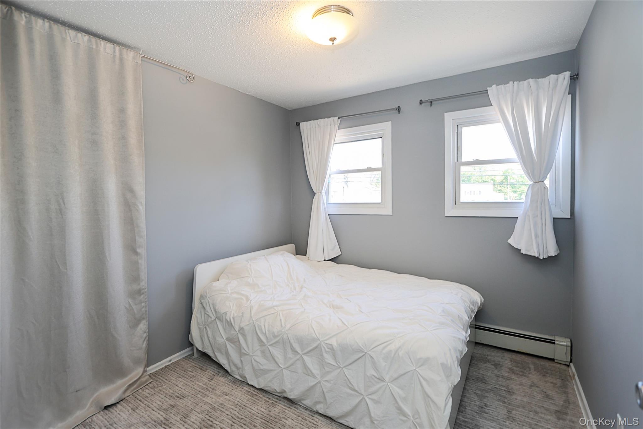 874 Seamans Nck Road Wantagh, NY 11793 - Photo 23 of 39 a bedroom with a bed and a window