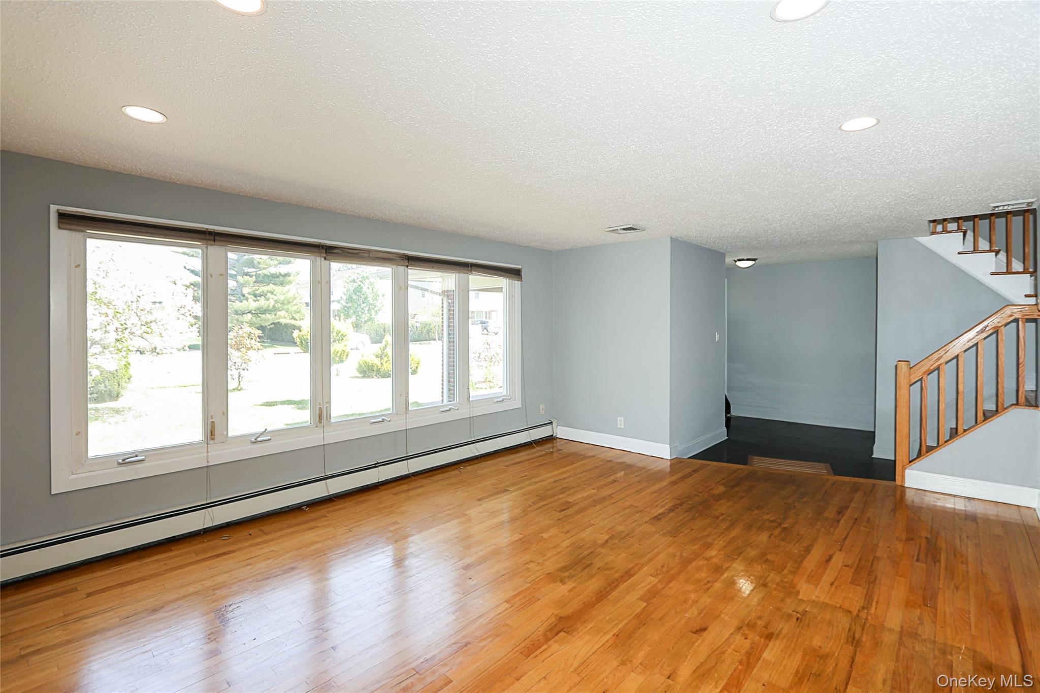 874 Seamans Nck Road Wantagh, NY 11793 - Photo 7 of 39 a view of an empty room with a window and wooden floor