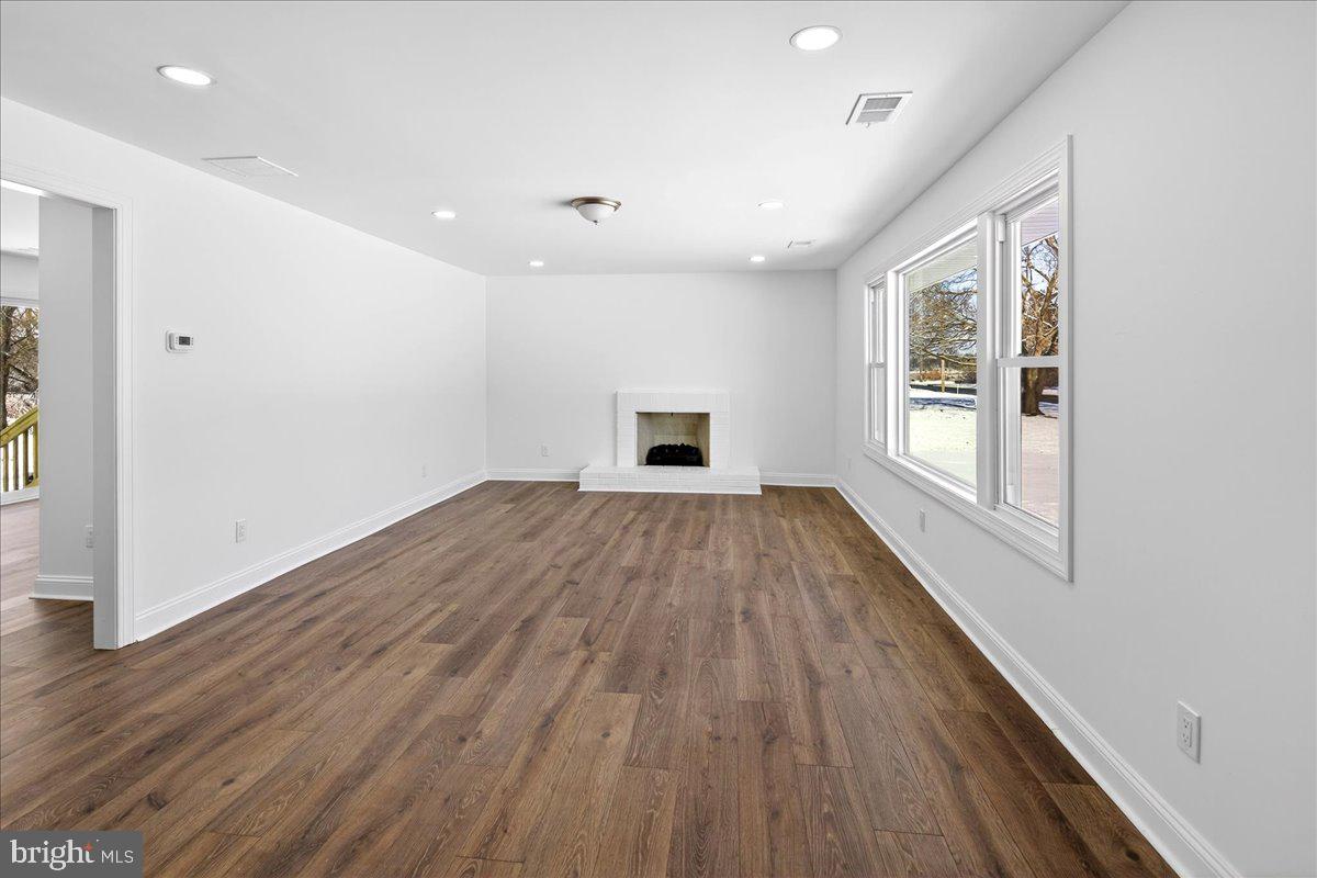 464 Sykesville Road Wrightstown, NJ 08562 - Photo 5 of 32 an empty room with wooden floor cabinet and windows