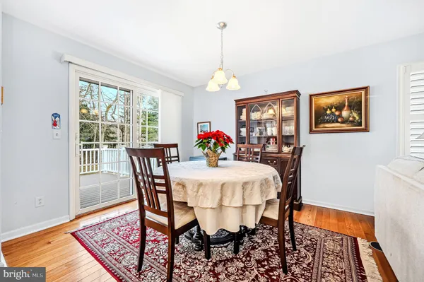 a kitchen with granite countertop white cabinets white appliances a sink and a window